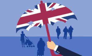 Britannian lipun värisen sateenvarjon alla on erilaisia ihmisiä varjohahamoina. Sateenvarjossa on reikiä ja sitä pitelee pukuhenkilön käsi.
